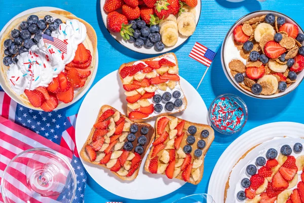 stock image Fourth of July, Patriotic Independence day desserts.  4th of July sweet brunch food and snacks - toast sandwiches, flakes with berries, cake, pancakes, champagne with glasses, holiday decor, flags 