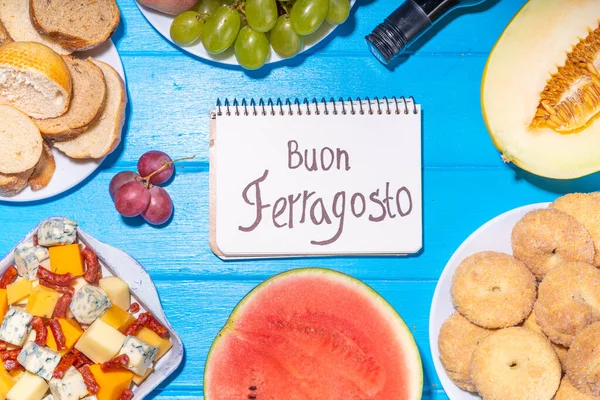 Buon Ferragosto (happy in italian language) holiday background. Summer Italian harvest festival August 15  brunch, family party antipasto foods with watermelon, melon, grapes, cheese, snacks, drinks