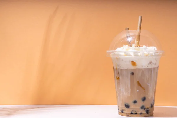 stock image Tapioca boba balls coffee frappe, asian trendy cold coffee drink with tapioca balls and whipped coconut cream and caramel sauce