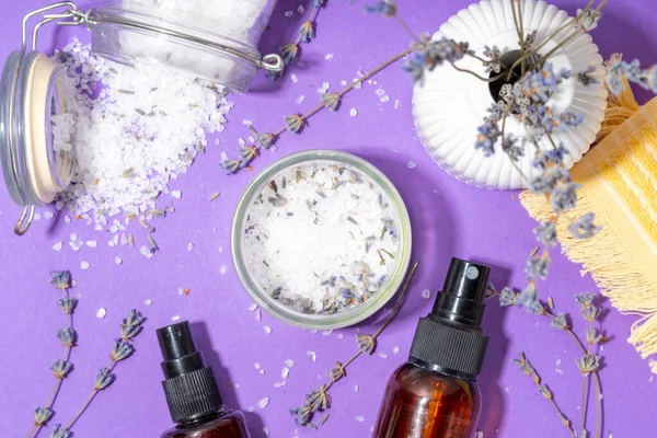 Cosmetics with lavender oil and dry lavender flowers. Aromatic essential oil, lavandula salt, spray, beauty care, wellness and natural beauty concept