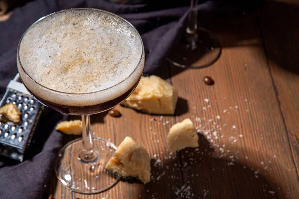 Parmesan Cheese Espresso Martini Cocktail, cheesy whipped coffee drink in martini glass with grated parmesan