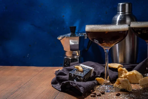 Parmesan Cheese Espresso Martini Cocktail, cheesy whipped coffee drink in martini glass with grated parmesan