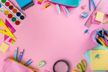 Okul ekipmanları parlak pembe düz yerde yatıyordu. Çeşitli okul ve ofis malzemeleri, aksesuarlar. Okul satışına geri dön. Üst görünüm kopyalama alanı