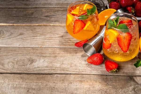 Homemade Summer Sparkling White Wine Sangria. Cold fizz fruit and berry infused alcohol drink, non-alcohol lemonade with fresh strawberry and orange, copy space