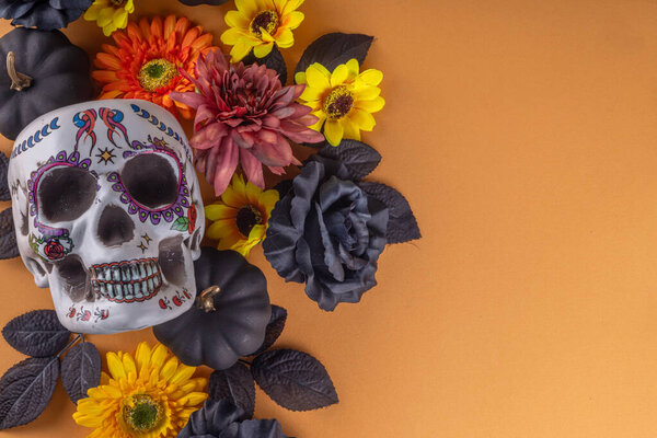 Dia de los muertos Feast flat lay, Mexican Day of the Dead holiday background with fall black, orange, yellow flowers, lightbox with text Dia de los muertos, colorful painted skull