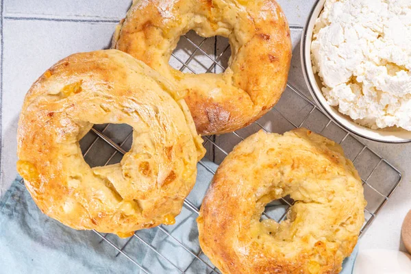 Cottage cheese bagels. Trendy curd cheese baking, bread rings with cottage cheese and parmesan, savory non-sweet breakfast baked cheesy donuts