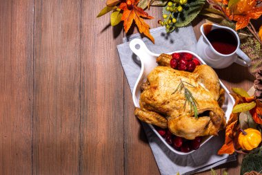 Thanksgiving dinner turkey or chicken baked with fresh cranberries, rosemary, spices. With cranberry sauce on a wooden lunch table clipart