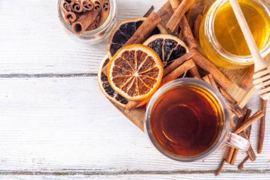 Basit tarçın, portakal ve bal çayı kupası ahşap masada malzemeler, alternatif soğuk algınlığı ilacı içecek tarifi, kopyalama alanı.