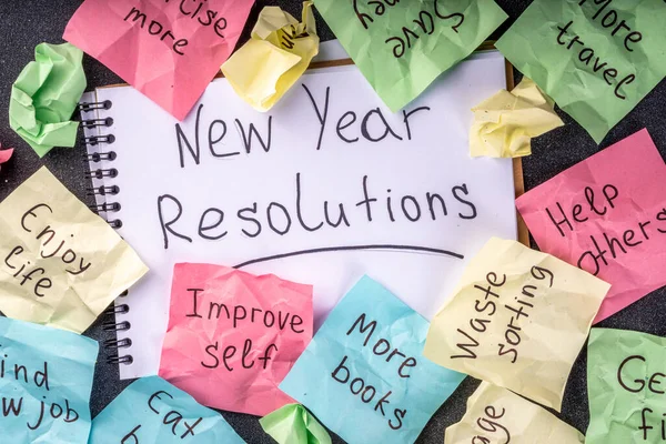 New year goals or resolutions on bright colorful paper stickers. New Year goals List 2023, plan listing of new year beginnings goals and resolutions setting. Flat lay copy space on black background
