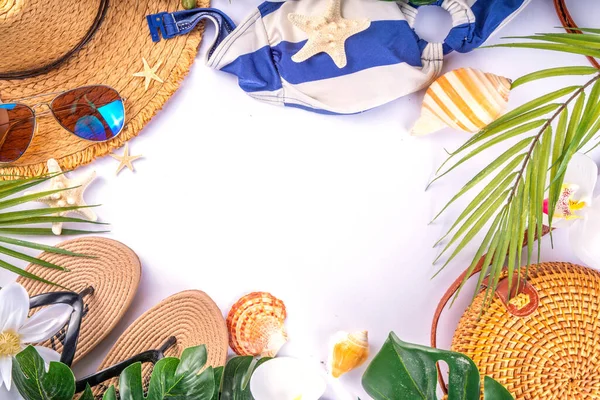 stock image Tropical vacation beach getaway background. Flat lay with summer accessories, sunglasses, sun hat, sandals, starfish, palm leaves, top view on white background with copy space