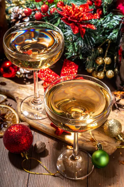 Merry Christmas and New Year holiday celebration with champagne. on wooden table with Christmas tree and decoration