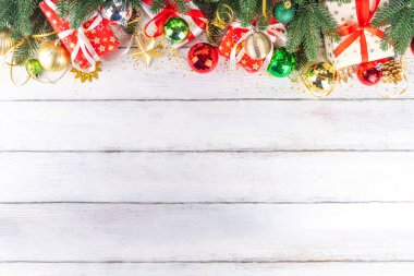 Noel ve yeni yıl tebrik kartı geçmişi, bayram kurdeleli hediye kutuları, noel ağacı dalları, altın, kırmızı, yeşil bayram dekoru, takılar ve kostüm ağacı topları, üst görünüm kopyalama alanı