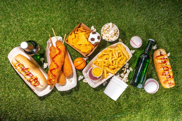 stock image Traditional sport stadium foods and beer background, Set of various baseball, basketball, football fans and stadium snacks, chips, sauces, hot dogs with beer bottles and fan accessories 