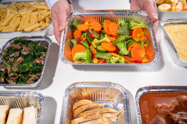 stock image Batch Cooking Meal Prep concept. Several types of side dishes: cereals, pasta, pasta, cooked and fresh vegetables, meat, chicken, nuggets, breakfast pancakes and fruit in food containers 