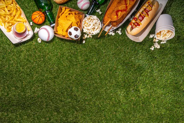 Traditional sport stadium foods and beer background, Set of various baseball, basketball, football fans and stadium snacks, chips, sauces, hot dogs with beer bottles and fan accessories