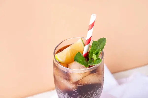 Cuba Libre or long island iced tea cocktail with strong drinks, cola, lime and ice in glass, cold long drink or lemonade