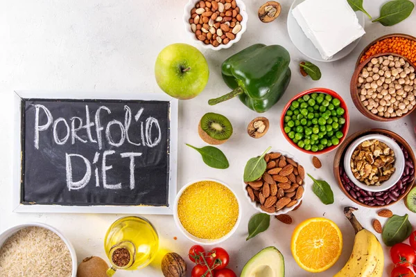 stock image Portfolio Diet, balanced lowering cholesterol vegan food, including nuts, vegetable protein, plant sterols, viscous fiber, beans, legumes, fresh vegetables and fruits on white background copy space