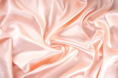 Basit, güzel, saten kumaş arka plan. Nazikçe pembe inci krem dalgalar katlanmış saten kumaş, ışık parıltıları, yüzey, düz yatar taklit kopya alanı ürün veya metin için