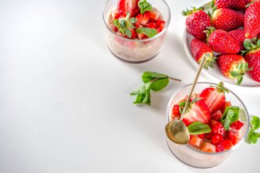 Bir gecede yulaf ezmesi hazırla. Çilekli yulaf lapası, muz, çikolata, küçük porsiyon kavanozlarda fındık. Yaz kahvaltısı yulafı. Sağlıklı vejetaryen diyeti.