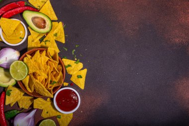 Traditional Mexican street food, fast food background, corn Taco, nachos with meat, vegetables, avocado, beans, corn, salsa. Served with various sauces. Mexican holiday flatlay