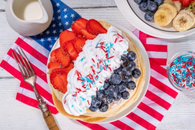 Holiday 4th of July breakfast pancakes, battercakes with whipped cream and berries like american flag. Homemade Patriotic sweet brunch or snack food, idea for party treat and desserts clipart