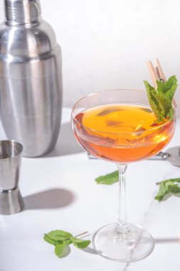 Old cuban alcohol cocktail. Boozy drink with white rum, lime, mint, sparkling wine, sweet and bitter alcoholic drink on white background with hard light and bar utensils clipart