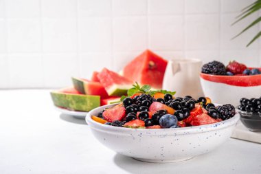 Yaz meyveli salata ve tapyoka incileri. Beyaz masa arkasında karpuz, çilek, yabanmersini ve balonlu çay toplarıyla sağlıklı diyet ferahlatıcı salata fotokopi alanı