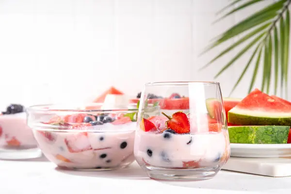 stock image Subak Hwachae cocktail, Korean traditional watermelon punch salad drink, with a lot of fruit slices, with tapioca boba pearls, in glass and bowl for party, copy space