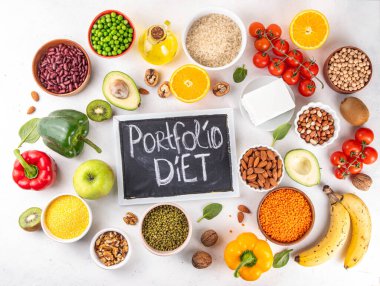 Portfolio Diet, balanced lowering cholesterol vegan food, including nuts, vegetable protein, plant sterols, viscous fiber, beans, legumes, fresh vegetables and fruits on white background copy space clipart