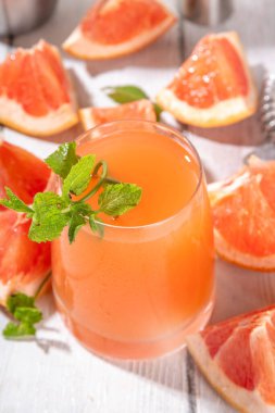 Soğuk greyfurt mojito içeceği, tekila pembe paloma, ferahlatıcı limonata pembe greyfurt suyu ve naneli, beyaz ahşap masa üzerinde, kopyalama alanı