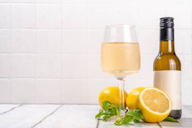 Dilimlenmiş limon ve nane aromalı nefis narenciye şarabıyla limon şarabı ve şişe. 
