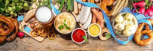 stock image Oktoberfest holiday greeting card, menu, invitation background, Traditional Oktoberfest festival food, bavarian sausages, pretzels, potato, sauerkraut, beer mug on wooden background, banner format