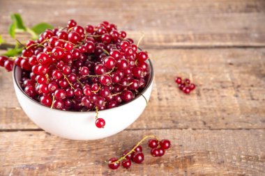 Ahşap masa fotokopi alanında çiğ organik frenk üzümü kasesi.