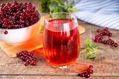 Kırmızı frenk üzümü suyu veya cam içinde likör, ahşap masa arkasında, naneli ve taze üzümlü üzümlü fotokopi alanı