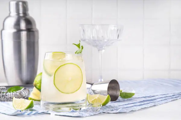 stock image Summer cold refreshment limeade cocktail, cold alcohol or non-alcohol beverage with limes, mint ans ice cubes, copy space