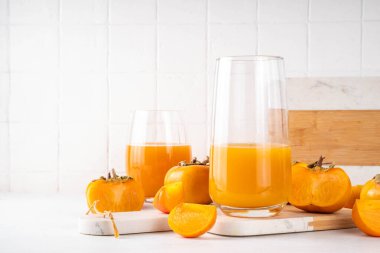 Porsiyonlu bardaklarda taze ev yapımı hurma suyu. Arka planda da da bir bütün ve kesilmiş hurma ağacı var.