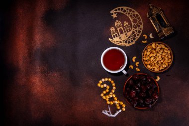Ramazan Müslüman bayramı geçmişi, geleneksel ikramlar - tarihler, fındıklar, kurutulmuş meyveler, tatlılar, din tespihi, fener, çay, İslami cami, hilal ayı temalı Ramazan Kareem dekorasyonları