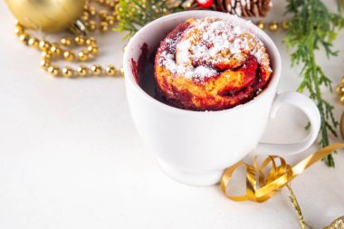 Christmas candy cane striped red and white mugcake. Portioned quick microwave baked dessert with white and red velvet sponge cake, with sugar powder on top clipart