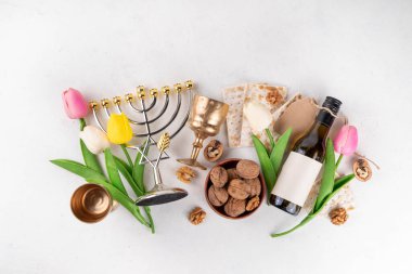 Hamursuz Bayramı geçmişi. Geleneksel Yahudi ekmek matzası, kırmızı koşer şarabı, ceviz, bahar güzel çiçekleri. Yahudi Paskalya Pesah bahar tatili arka plan kopya alanı