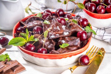 Sweet dessert chocolate dumplings vareniki with cherry berries and chocolate sauce, with sugar powder. Traditional ukrainian, polish, east european pierogi dumplings clipart