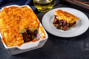 Vegan Sheppard Pie Recipe. Traditional English pie with mashed potatoes, with base of legumes, beans and corn instead of meat. Vegan source of protein, balanced lunch or dinner idea clipart