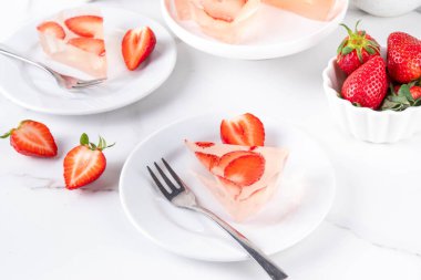 Japon yağmur damlası keki, ya da Mizu Shingen Mochi, berrak jöle tatlısı, kristal berrak su benzeri lezzetli, çilek dilimli tart, tabaklar üzerine porsiyonlu, beyaz mermer arka plan fotokopi alanı