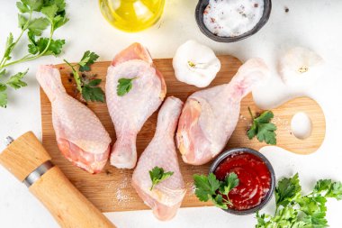 Tavuk eti hazırlama arka planı, ızgaraya hazır çiğ tavuk bacağı, baharatlar, tuz, biber, zeytinyağı, sarımsak ve salamura veya sos. Izgara ve bbq sezon pişirme arka planı, kopyalama alanı