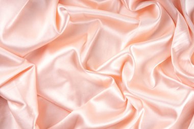 Basit, güzel, saten kumaş arka plan. Nazikçe pembe inci krem dalgalar katlanmış saten kumaş, ışık parıltıları, yüzey, düz yatar taklit kopya alanı ürün veya metin için