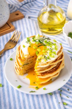 Lezzetli kahvaltı krepleri, taze soğan ve kızarmış yumurta. Lezzetli ya da tatlı olmayan krepleri beyaz mutfak masasında maydanozlu ve güneşli yumurtalarla fotokopi masasının üzerinde.