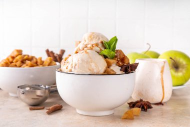 Ev yapımı elmalı turtalı dondurma. Bir kase geleneksel elmalı turta ya da elmalı turta, karamelli elma, bisküvi, karamel sosu, tarçın ve baharatlı.