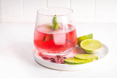 Hibiscus Suyu veya limonata, yaz aşılamalı çiçek suyu buzlu amber çayı, limon dilimleri ve nane, ferahlatıcı ve soğutucu, sağlıklı su, pembe doğal kokteyl.