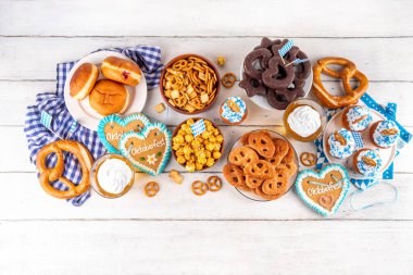 Oktoberfest festival yemekleri, çeşitli atıştırmalıklar, tatlılar, tatlılar, krakerler, bira jölesi, zencefilli kurabiye kalpleri, tuzlanmış krakerler, patlamış mısır, reçelli çörekler, kekler. Oktoberfest brunch menüsü arkaplanı