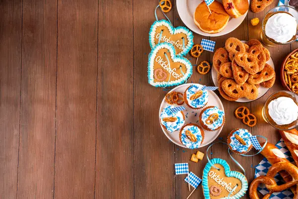 Oktoberfest festival yemekleri, çeşitli atıştırmalıklar, tatlılar, tatlılar, krakerler, bira jölesi, zencefilli kurabiye kalpleri, tuzlanmış krakerler, patlamış mısır, reçelli çörekler, kekler. Oktoberfest brunch menüsü arkaplanı