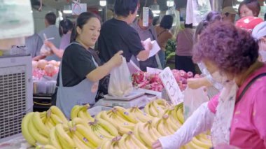 İnsanlar sebze pazarında sebze, meyve, et ve deniz ürünleri alıp satıyor, mutlu bir yaşam için alışveriş yapıyorlar ve yaşam ortamı güçlü. Gıda güvenliği.